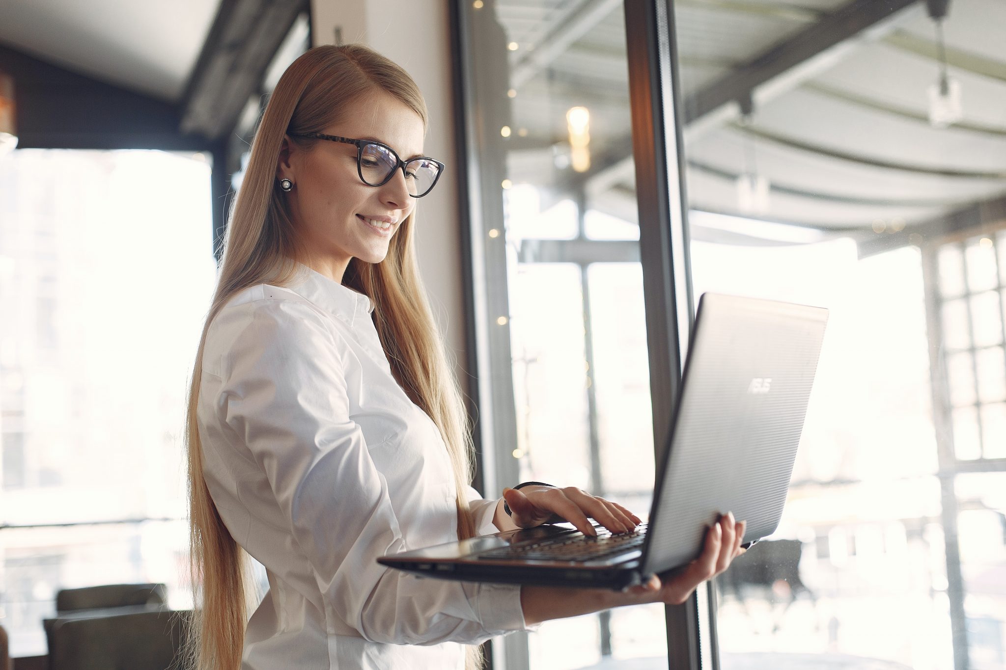 woman-in-white-long-sleeve-shirt-wearing-eyeglasses-using-3874621